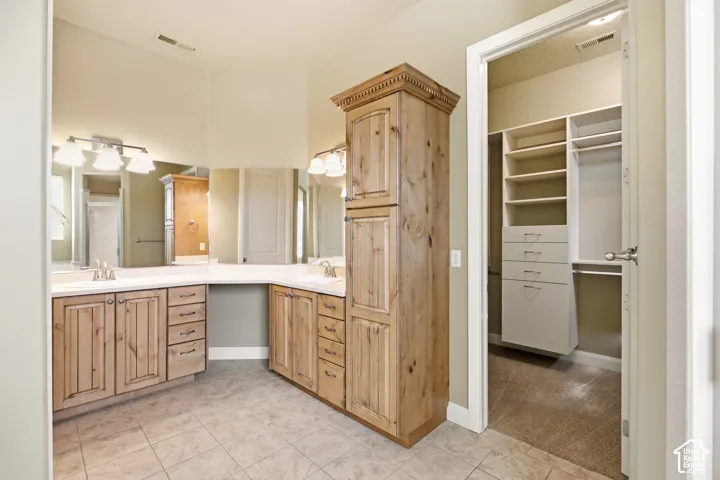 Dual vanity with wood-finish cabinetry and white countertops