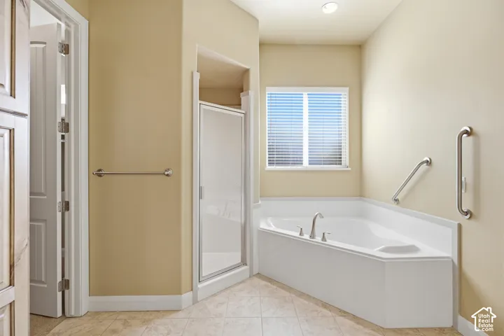 Corner soaking tub with stainless steel fixtures