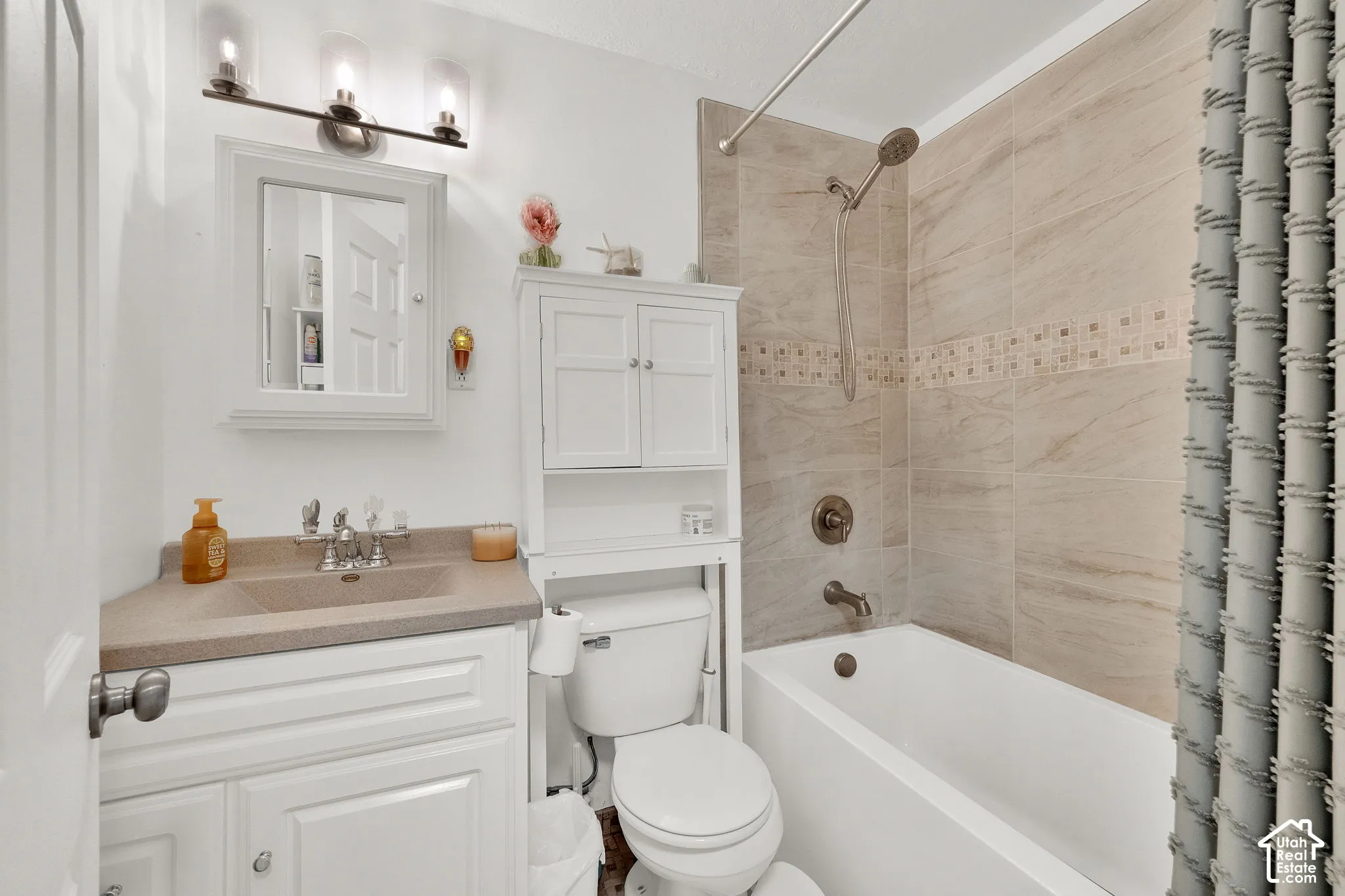 White vanity with an integrated sink and light-toned countertop