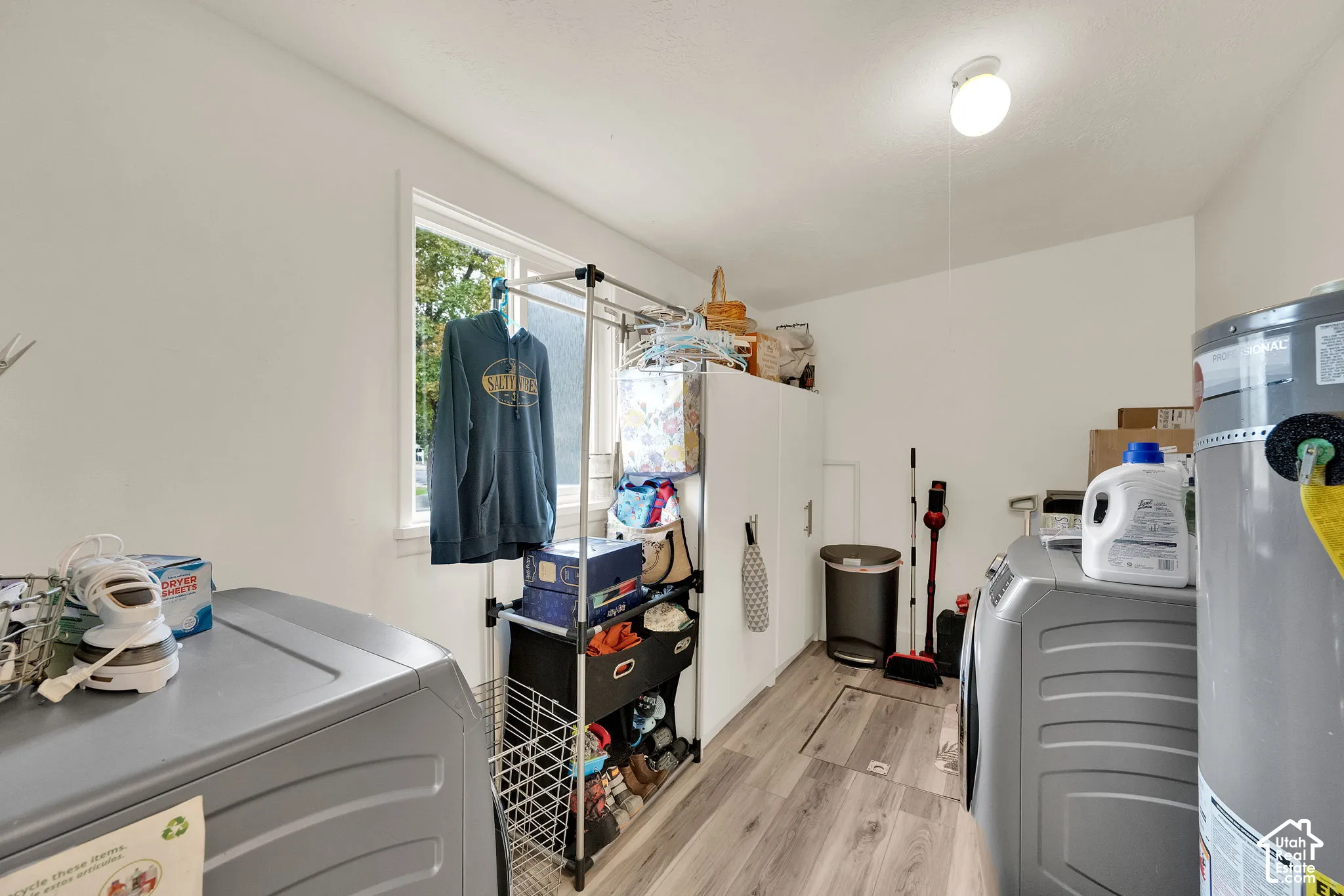 White walls, wood-finish flooring, and a single window