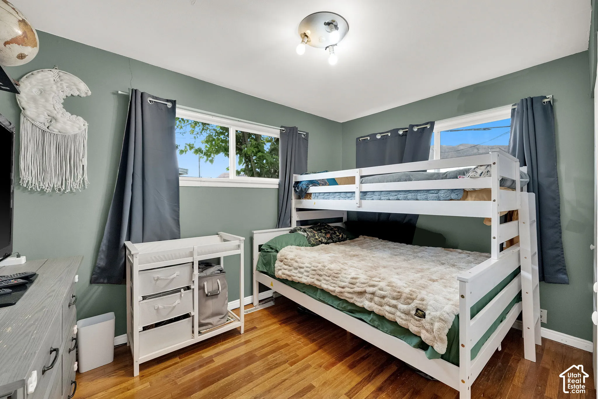 Wood-finish flooring with a multi-pane window and flush-mount ceiling light