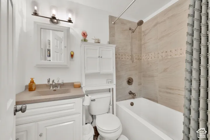 White vanity with an integrated sink and light-toned countertop