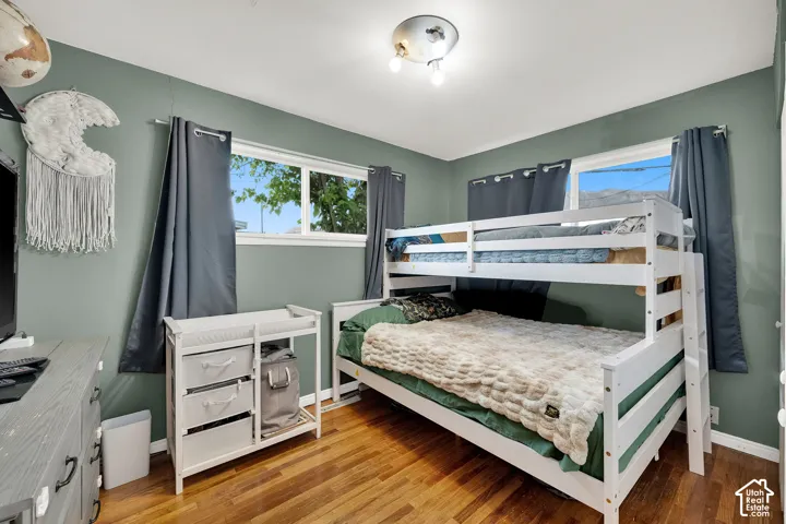 Wood-finish flooring with a multi-pane window and flush-mount ceiling light