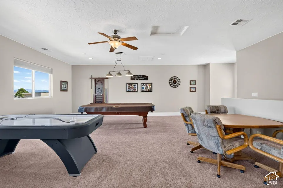 Expansive recreation room featuring carpeting, a ceiling fan, and recessed lighting