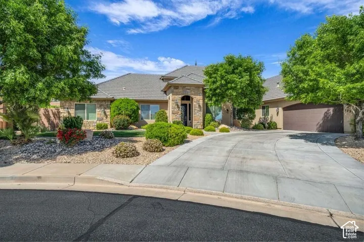 Stone and stucco exterior with an arched entryway