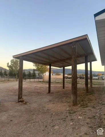 Metal roof carport with exposed wood framing and robust wood posts