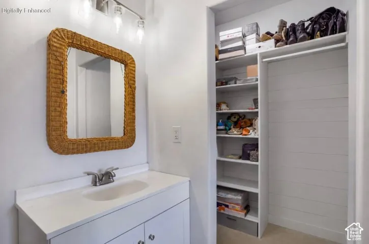 Vanity with integrated sink, dual-handle faucet, and wicker-framed mirror