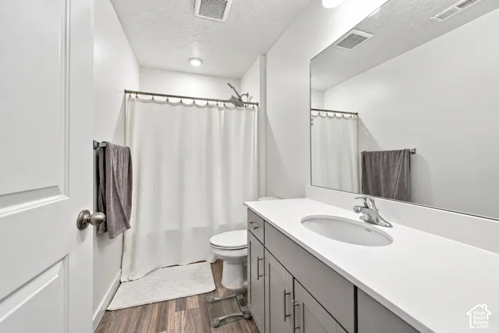 Vanity with an integrated sink, polished chrome faucet, and expansive mirror