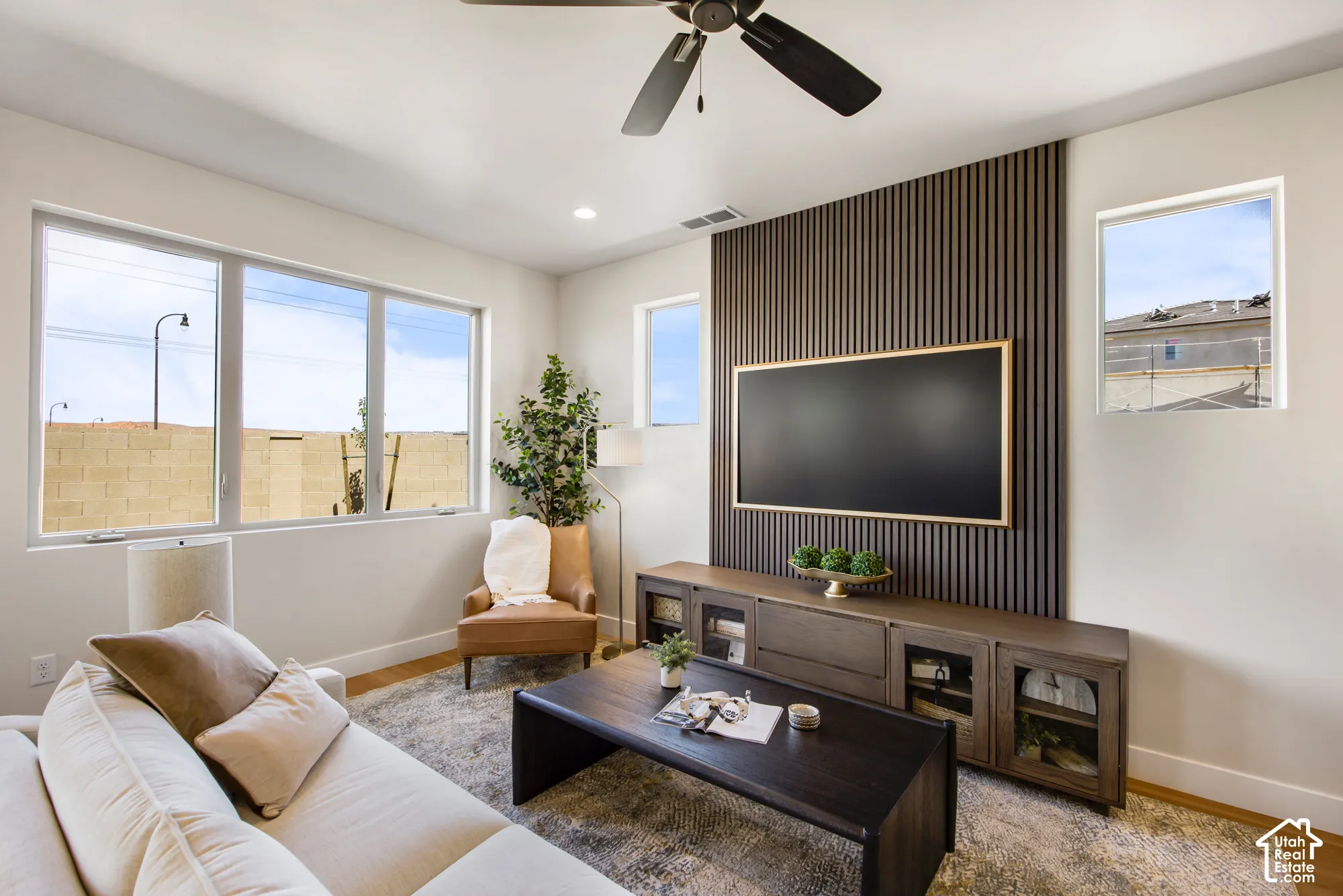 Recessed lighting and a ceiling fan enhance the living space