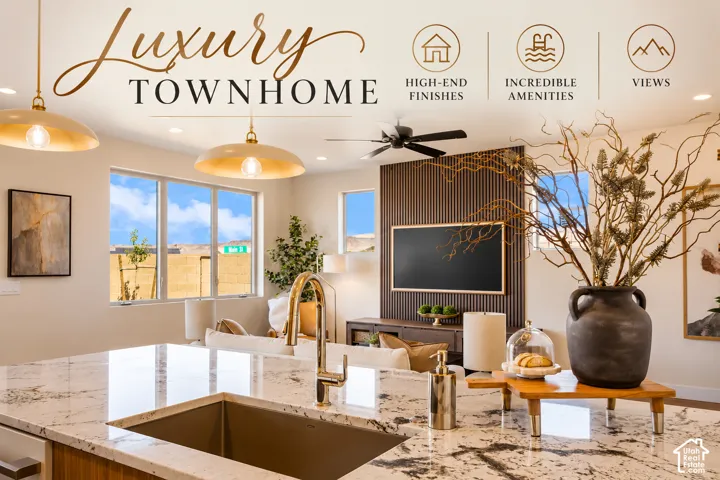 Spacious kitchen island with a built-in sink and gold-tone faucet, complemented by two large pendant lights