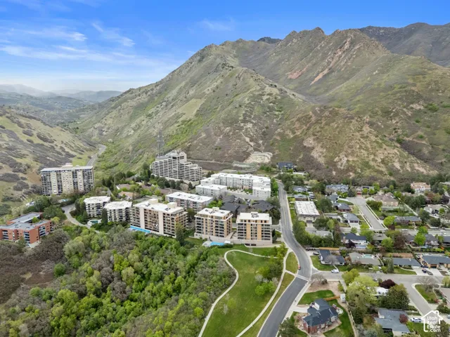 Mountain backdrop with a residential area and multiple multi-story buildings