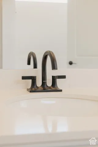 White countertop with an integrated sink and a matte black faucet