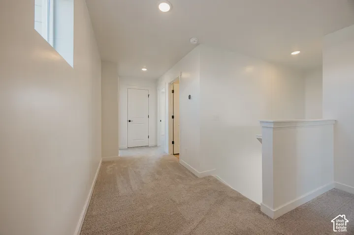 Neutral-toned carpeting throughout with white walls