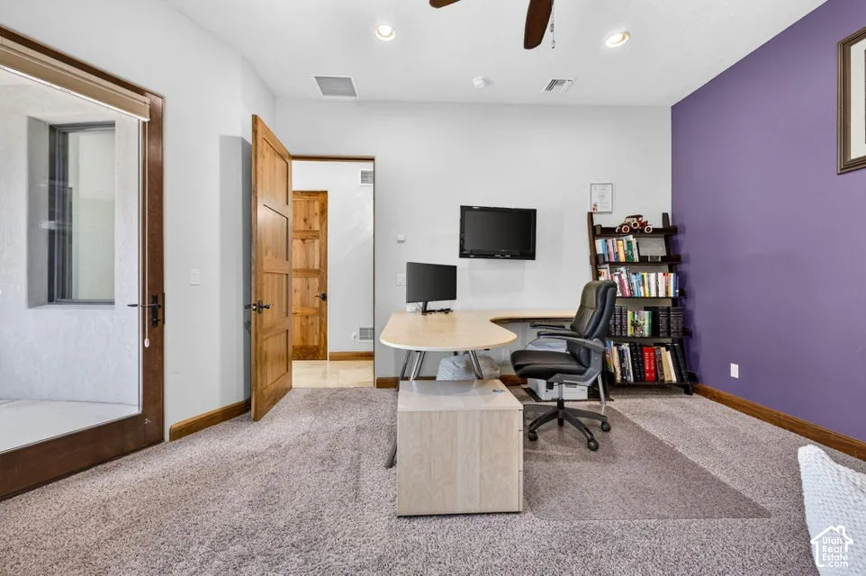 Carpeted room with a ceiling fan, recessed lighting, wood-finish doors, and a glass-paneled exterior door