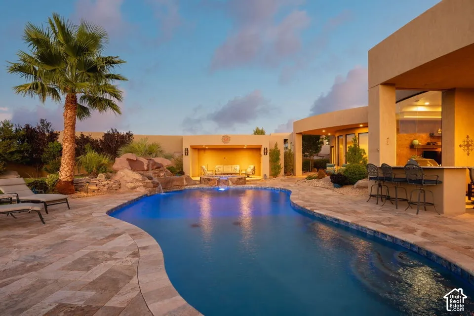 Freeform pool with a rock waterfall and integrated lighting