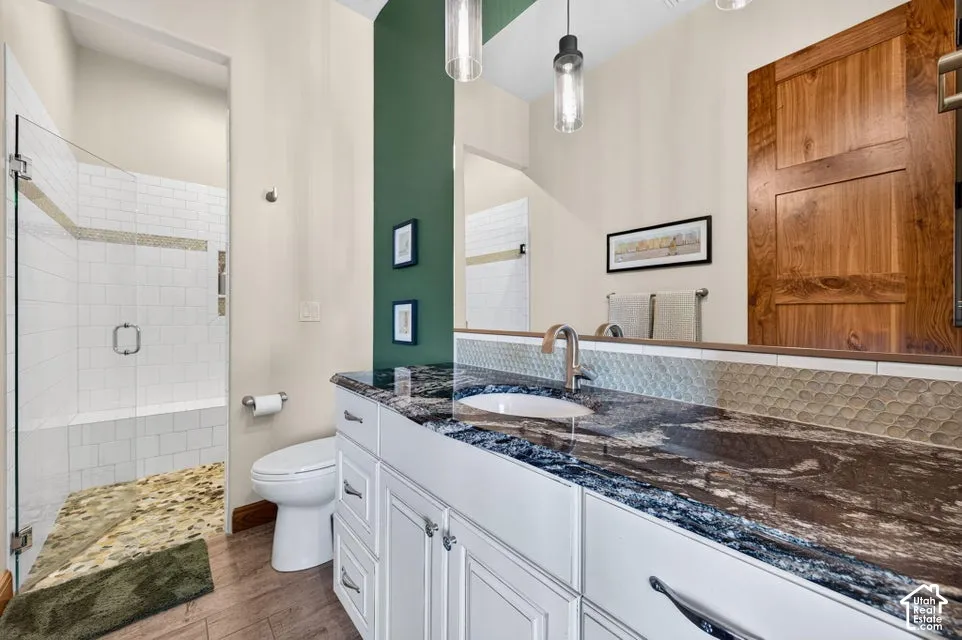 Glass-enclosed shower with subway tile, built-in bench, and pebble-tile flooring