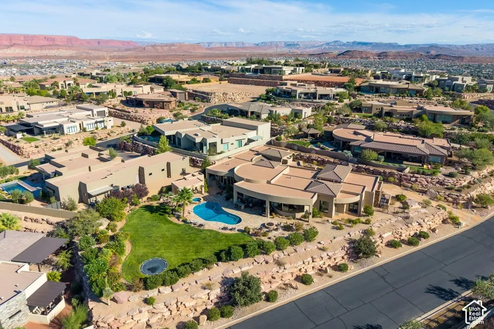 Expansive outdoor space featuring a swimming pool, manicured lawn, and mature landscaping