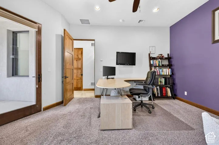 Carpeted room with a ceiling fan, recessed lighting, wood-finish doors, and a glass-paneled exterior door