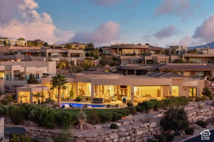 Terraced desert landscaping featuring natural rock formations and mature shrubs