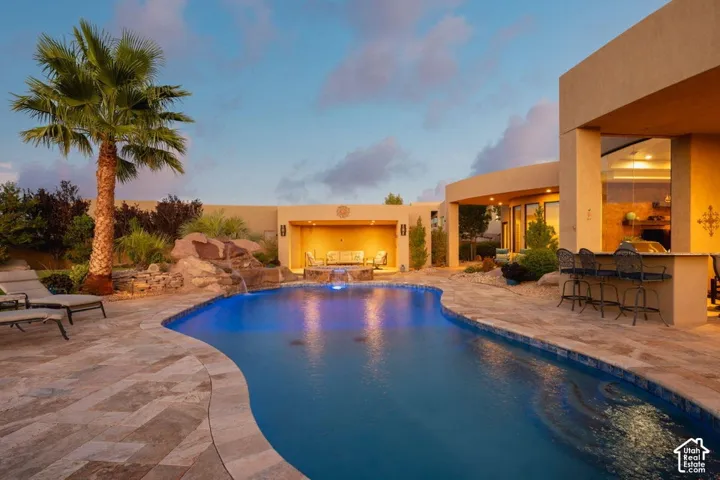 Freeform pool with a rock waterfall and integrated lighting