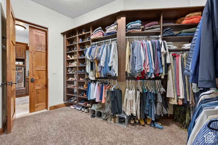 Custom built-in closet system with multiple shelving units, hanging rods, and integrated shoe storage