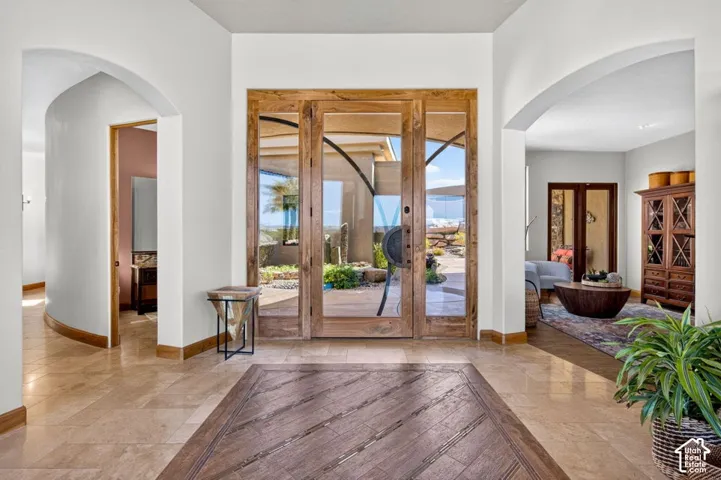 Wood-finish double entry doors with decorative hardware
