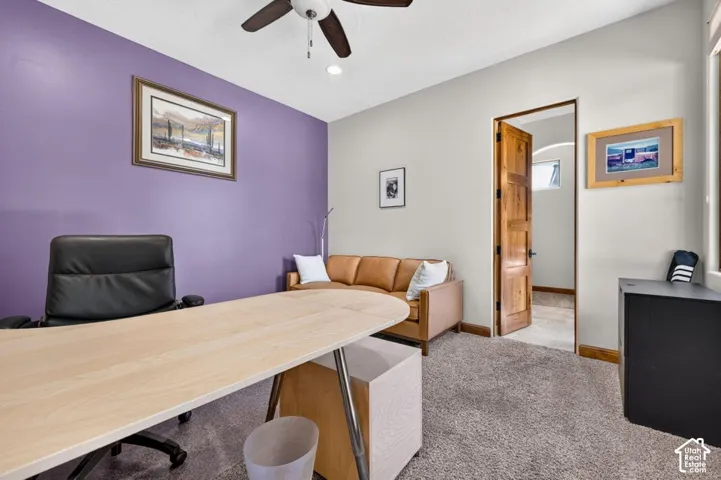 Recessed lighting, ceiling fan, wood-panel door, and carpeted flooring