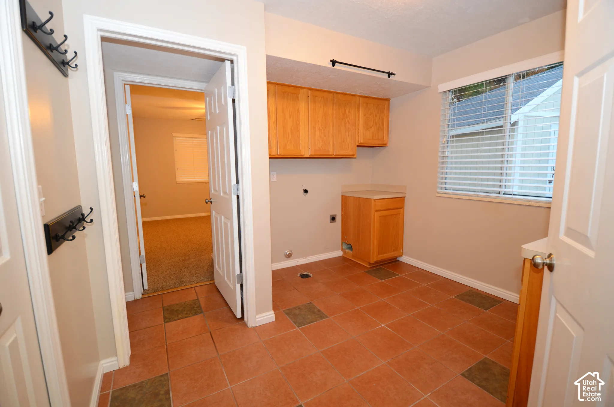Utility/Laundry/Mudroom features tile flooring, cabinetry, closet, and gas and electric dryer connections. A same level bath down the tile hall accomodates all the grease monkey, outdoorsmen and muddy kids bdofre they track in their outdoor activity in to