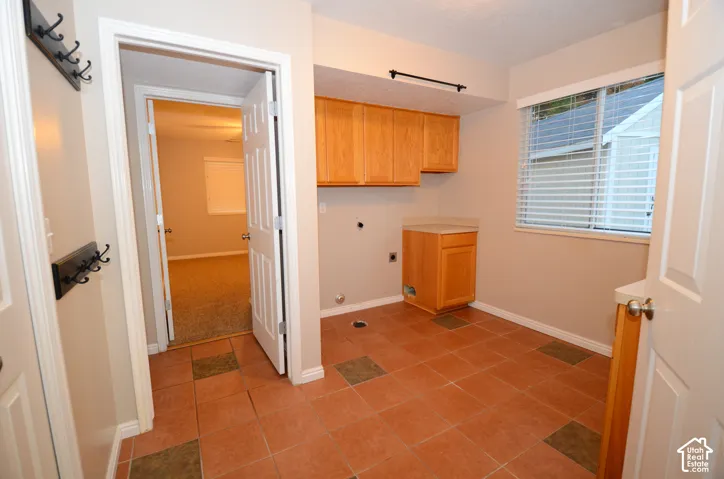 Utility/Laundry/Mudroom features tile flooring, cabinetry, closet, and gas and electric dryer connections. A same level bath down the tile hall accomodates all the grease monkey, outdoorsmen and muddy kids bdofre they track in their outdoor activity in to