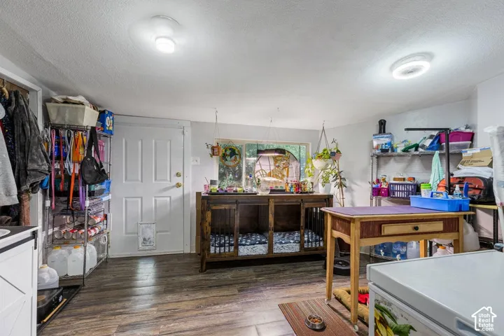Wood-finish flooring, white paneled door, and recessed lighting