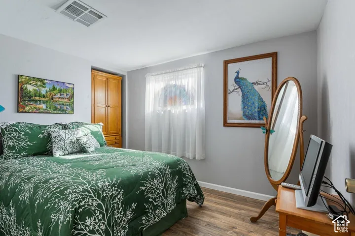Wood-finish flooring with a light-colored wall paint and a built-in wood-tone cabinet