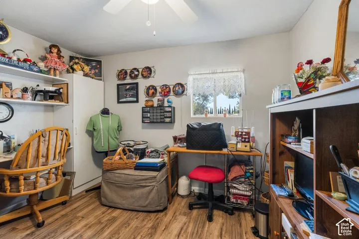 Wood-finish flooring with a ceiling fan light fixture