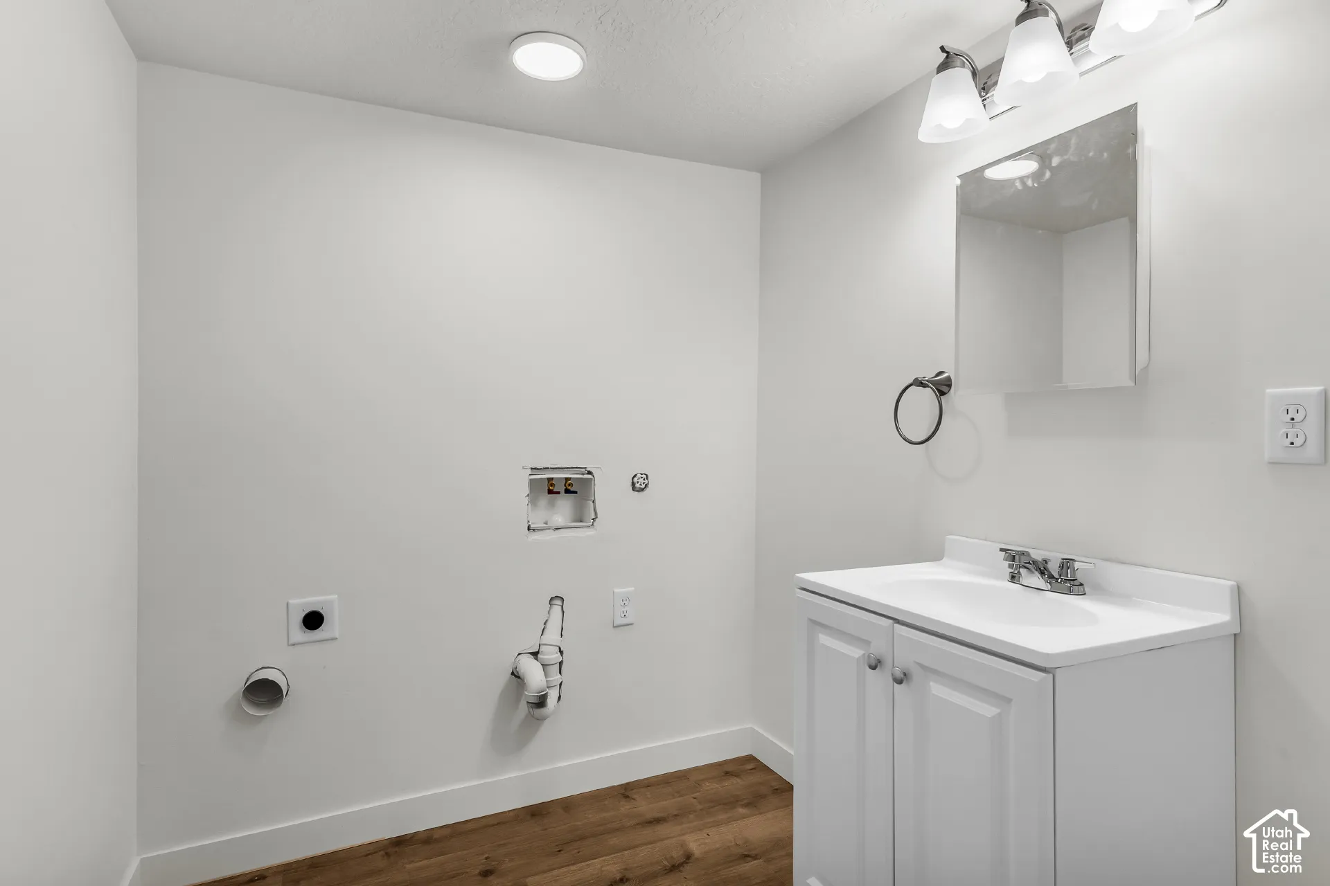 White vanity with an integrated sink and chrome faucet
