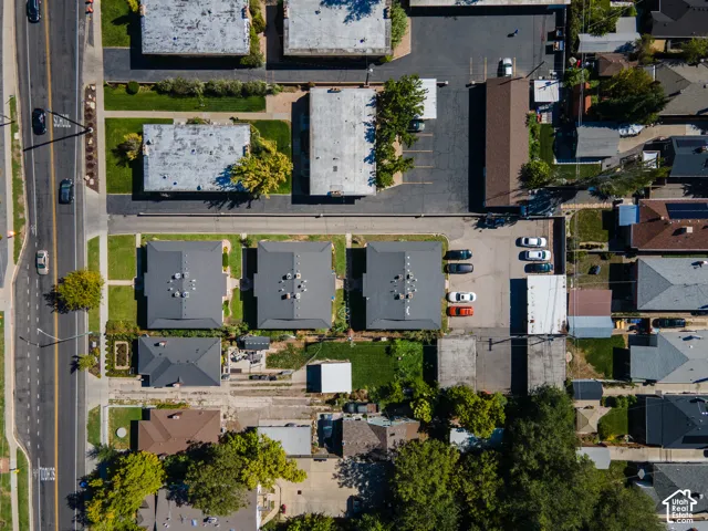 Aerial perspective showcasing multiple residential structures, paved roadways, and landscaped grounds