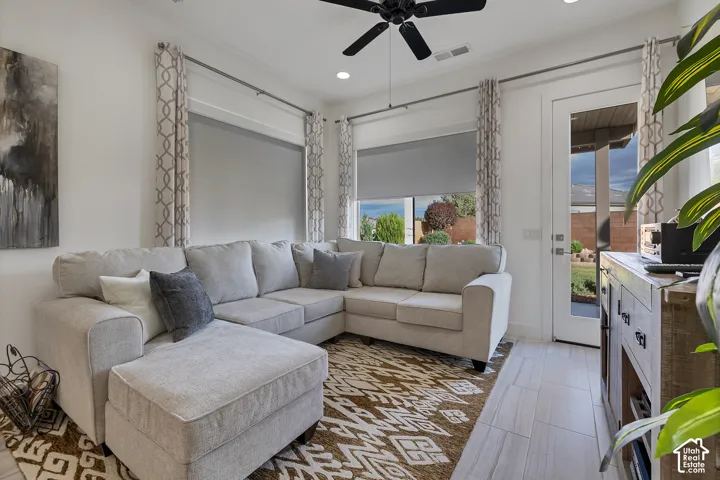 Recessed lighting illuminates the ceiling, complemented by a ceiling fan