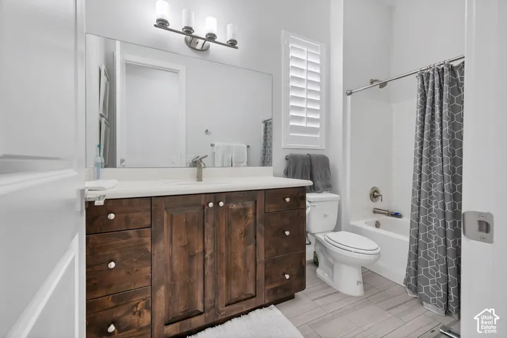 Wood-finish vanity with white countertop and integrated sink