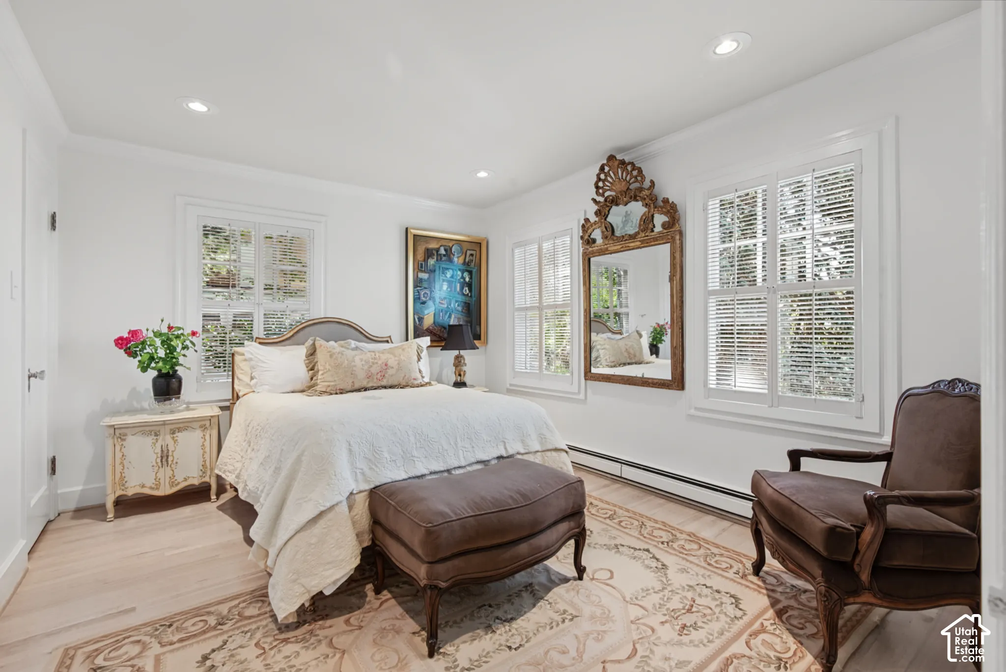 Recessed lighting, light wood-finish flooring, and multiple windows with white blinds