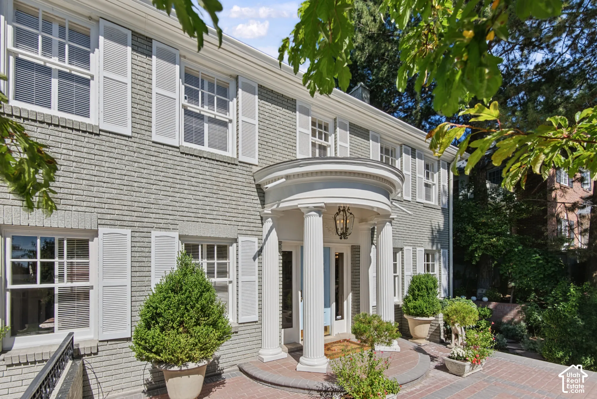 Brick exterior with white shutters and trim
