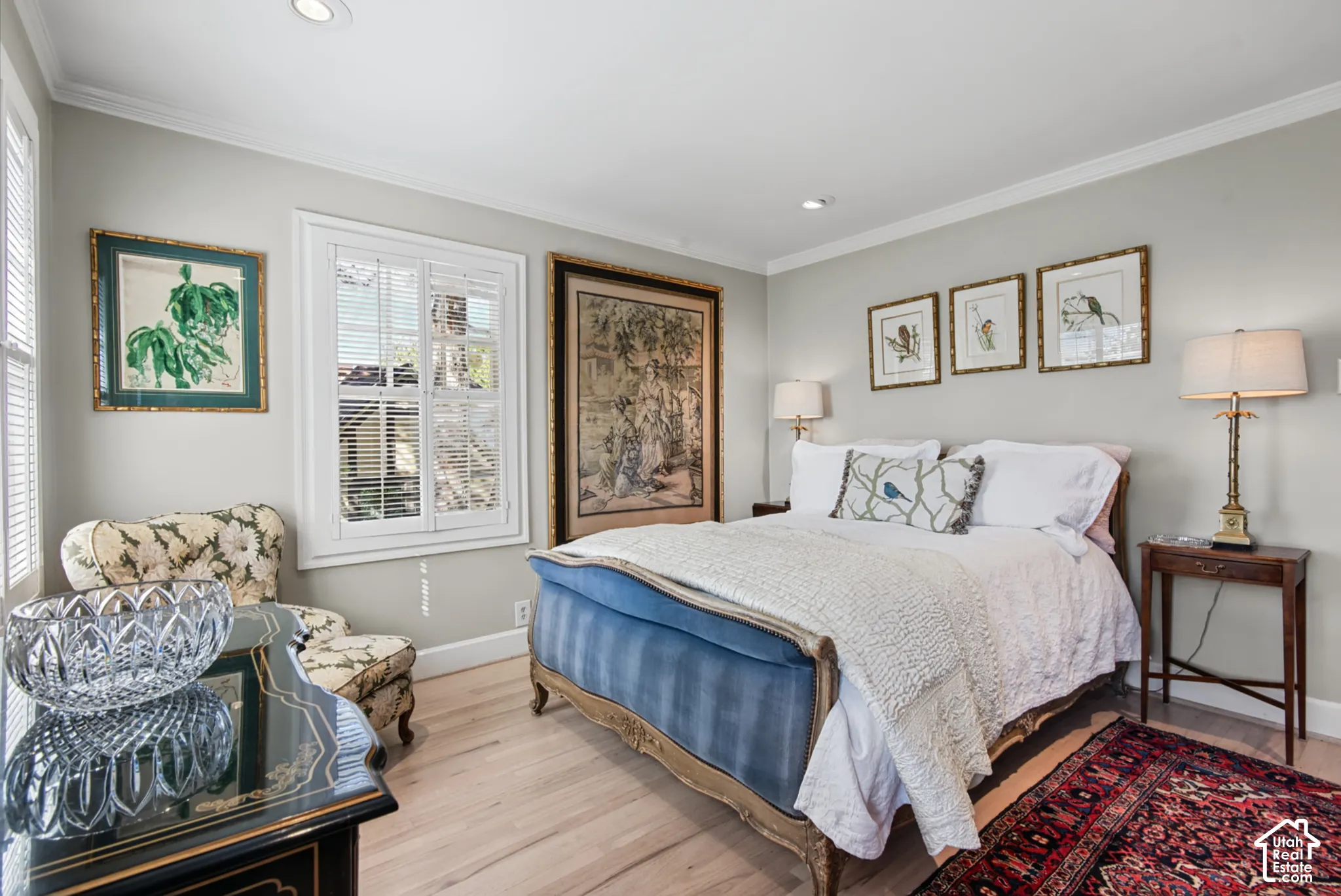 Recessed lighting, crown molding, double window with plantation shutters, light wood-finish flooring, and light wall paint