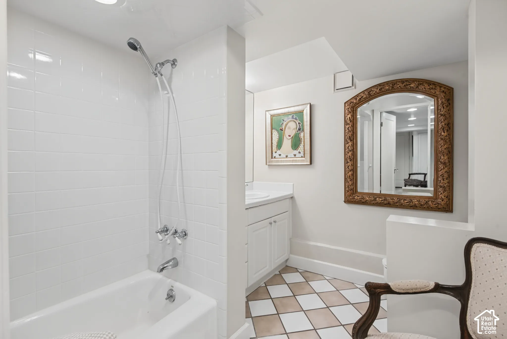 White tile shower with tub and chrome fixtures