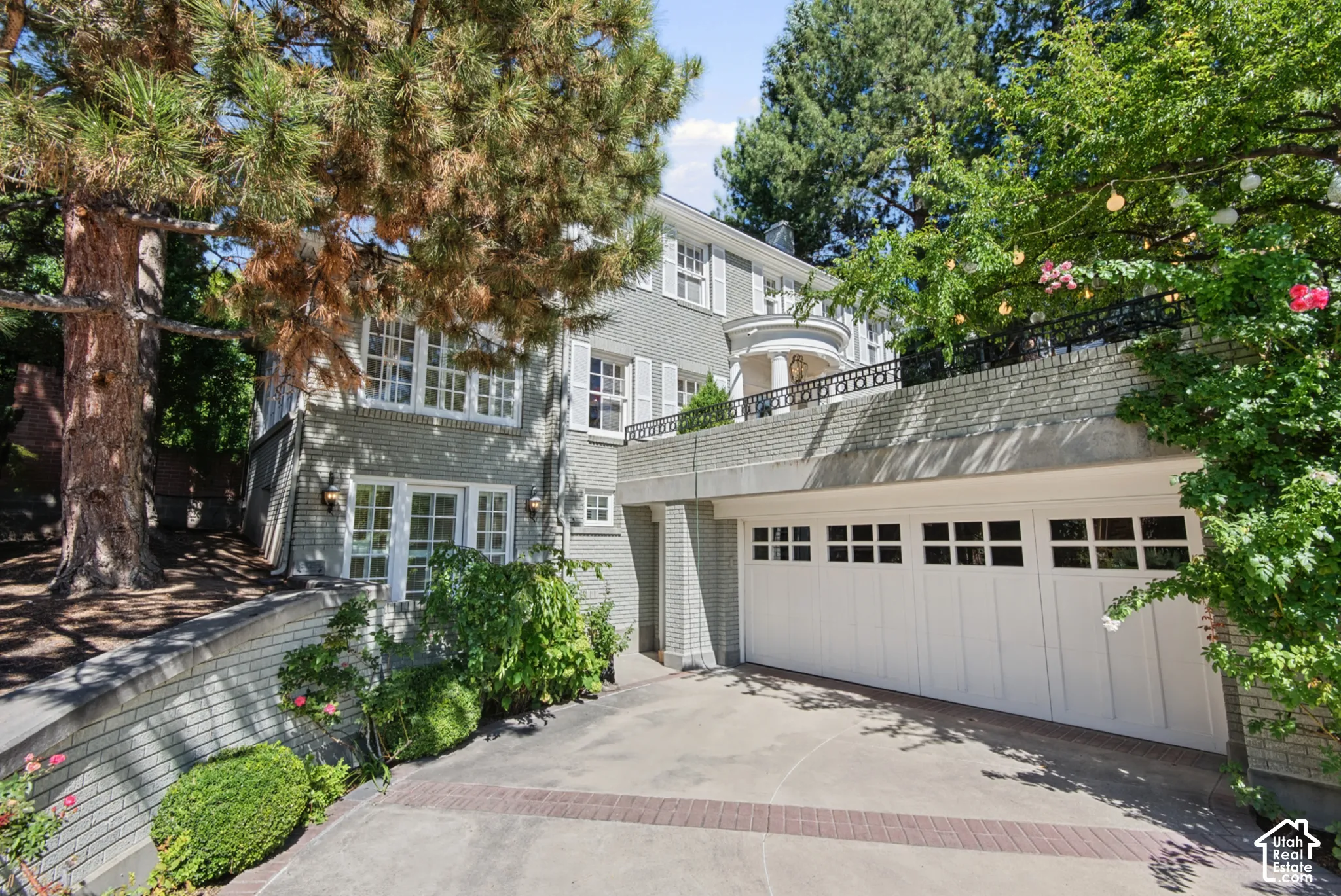 Brick exterior with white window shutters and a multi-car garage