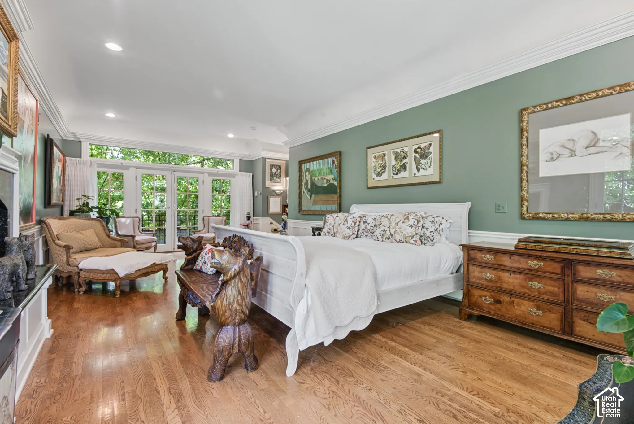 Hardwood flooring, French doors with transom windows, recessed lighting, crown molding, and a white fireplace surround