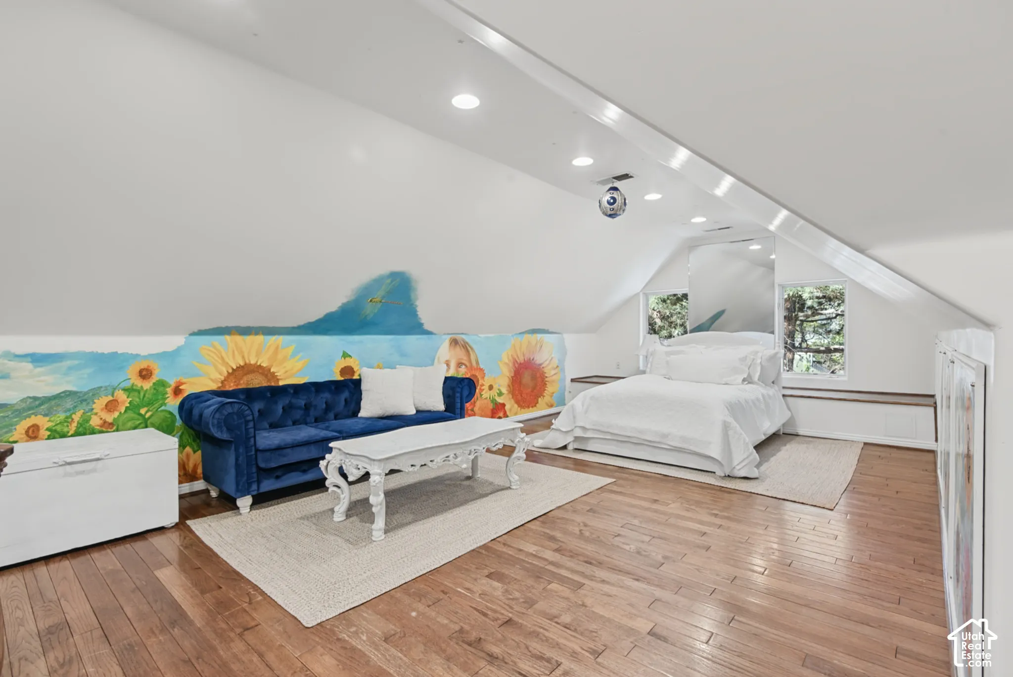 Vaulted ceilings with recessed lighting, wood-finish flooring, and built-in shelving