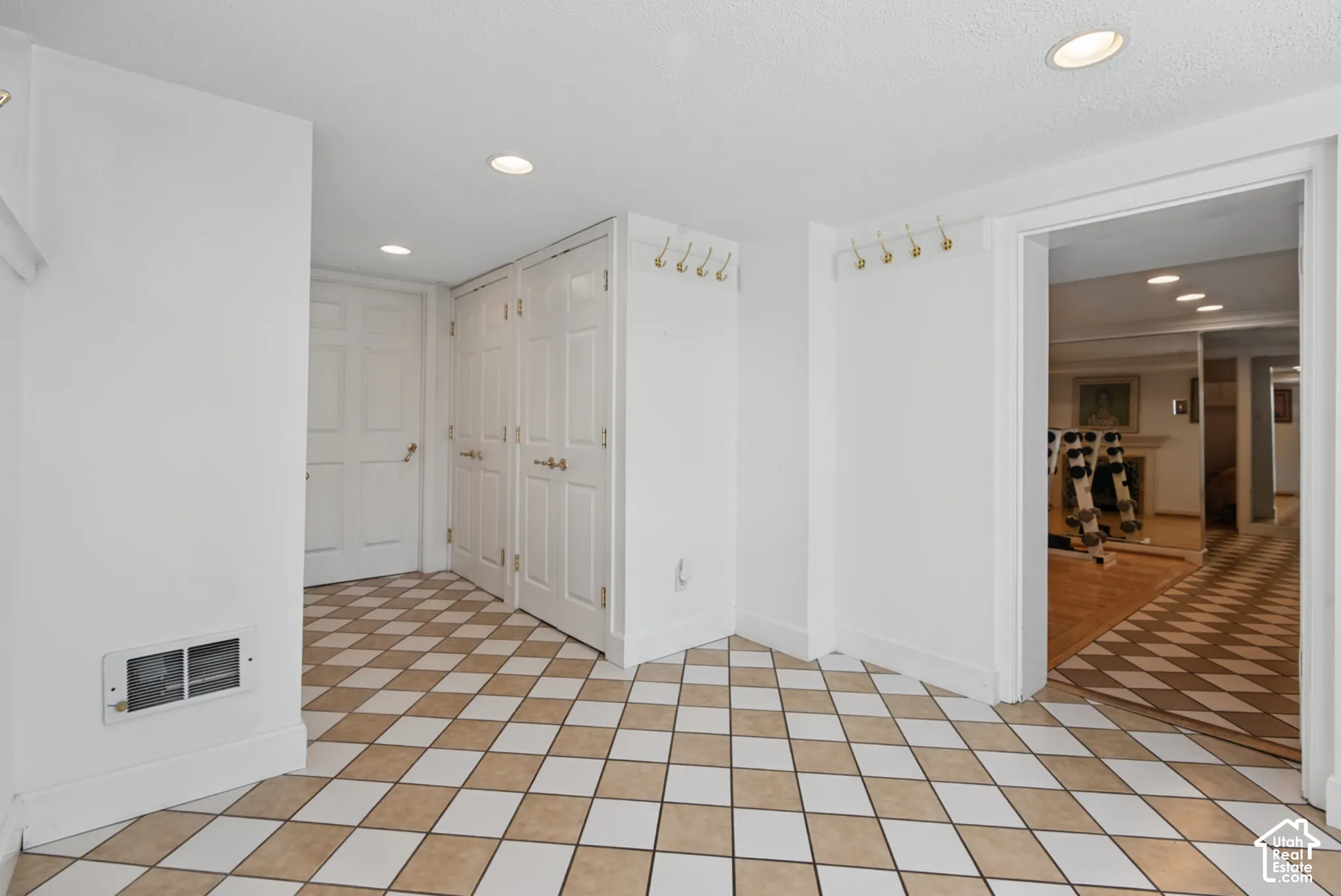 Tiled flooring with a diamond pattern, recessed lighting, and white paneled doors