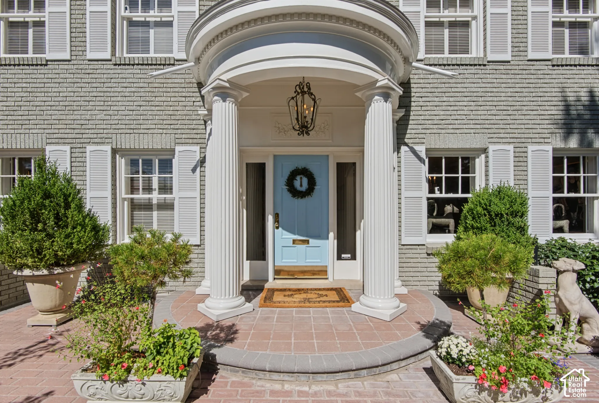 Brick exterior with white window shutters