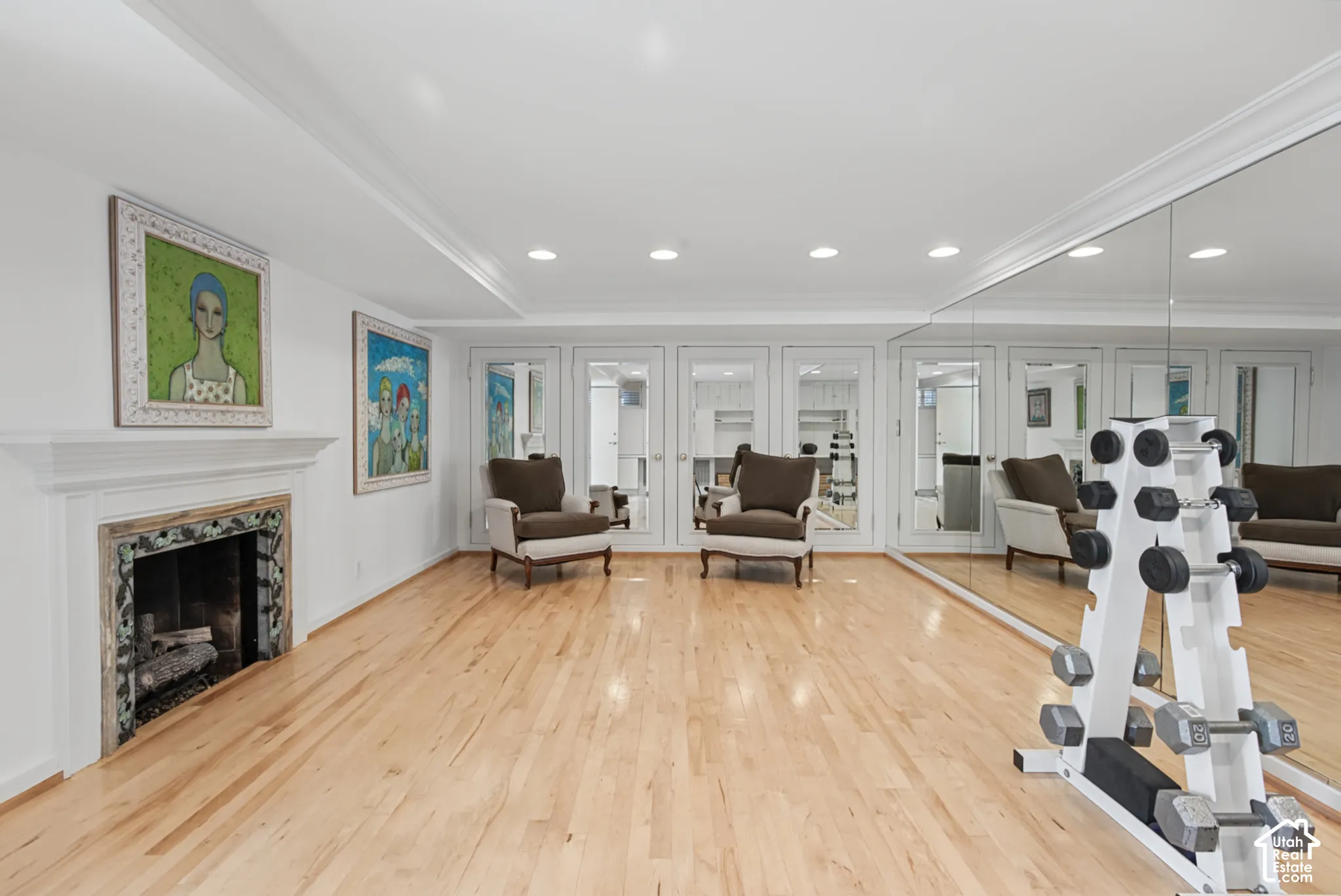 Hardwood flooring, recessed lighting, crown molding, built-in fireplace, mirrored wall