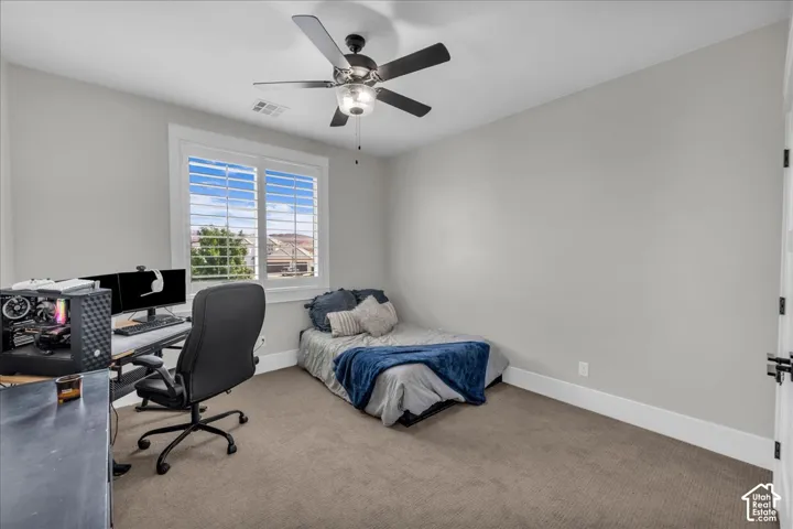 Recessed lighting, ceiling fan with light fixture, window with plantation shutters, light gray wall paint, and neutral carpeting