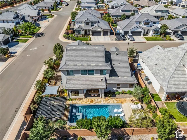 Architectural roofing, backyard swimming pool, and stone patio