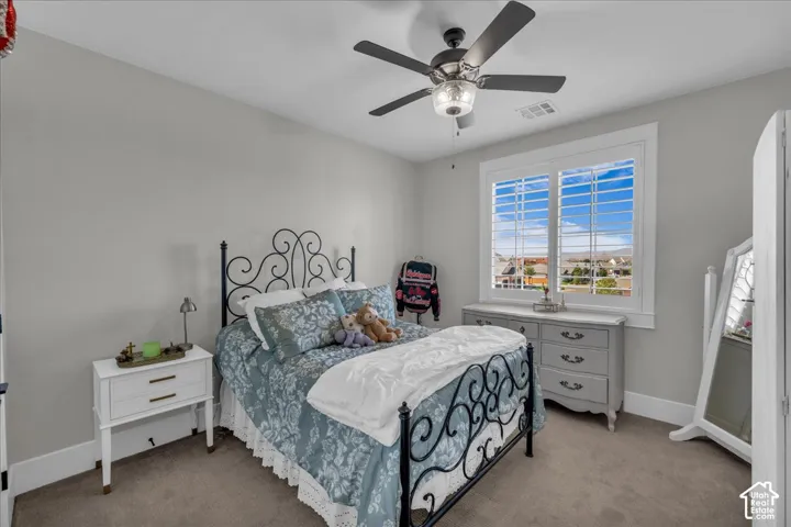 Window with white plantation shutters, neutral tone walls, recessed lighting, and a ceiling fan with integrated light
