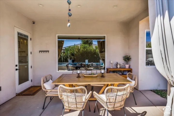Covered patio featuring a concrete slab, recessed lighting, and a prominent window